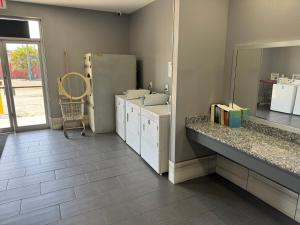 a bathroom with a sink and a counter with a mirror at Nola Inn & Suites in New Orleans