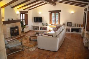 a living room with a couch and a fireplace at Villa with spectacular views in Jávea