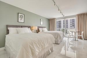 A bed or beds in a room at Ocean Views and Resort Perks Sunny Isles Beach Unit