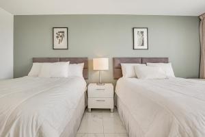 A bed or beds in a room at Ocean Views and Resort Perks Sunny Isles Beach Unit