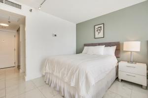 A bed or beds in a room at Ocean Views and Resort Perks Sunny Isles Beach Unit