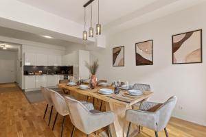 a dining room with a wooden table and chairs at MT Living - private Terasse - Whirlpool in Aschaffenburg