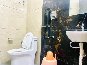 a bathroom with a toilet and a sink at Deccan Suites, Tirupati in Tirupati