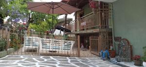 a patio with two chairs and an umbrella at Blue Fairytale in Agios Nikolaos