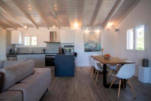 a living room and kitchen with a couch and a table at Villa Krokos in Corfu