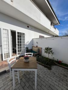 a patio with a wooden table and chairs on a patio at ValeHouse in Fiumicino