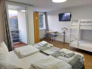 a bedroom with two bunk beds and a table at FeWo mit Pool in Baiersbronn in Baiersbronn