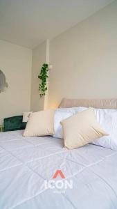 a bed with white sheets and pillows on it at Beautiful Studio in Barranco in Lima