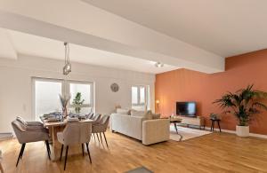 a living room with a couch and a table at MT Living - private Terasse - Whirlpool in Aschaffenburg