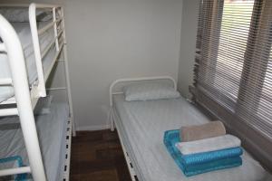 a bedroom with two bunk beds and a window at Ningaloo Coral Bay – Bayview in Coral Bay