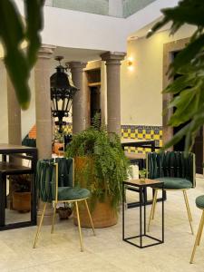 a group of chairs and tables in a lobby at Patio Zaragoza in San Luis Potosí