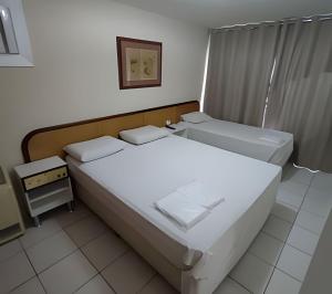 En eller flere senge i et værelse på Apartamento NossoLar - Garagem Feirinha e Hospitais