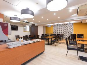 a large dining room with tables and chairs at APA Hotel Niigata Higashinakadori in Niigata