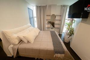 a bedroom with a bed with white pillows on it at Bright Studio in Barranco in Lima