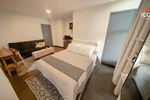 a small room with a bed and a couch at Bright Studio in Barranco in Lima