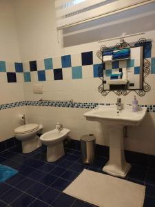 a bathroom with a sink and a toilet at Il Covo dei Sogni in Pratica di Mare