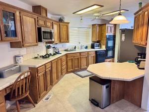 a kitchen with wooden cabinets and a counter top at Sagebrush Supreme in Parker
