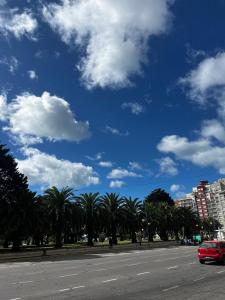 a street with palm trees and a blue sky at Departamento Plaza Colón Yeyita in Mar del Plata