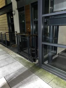 a glass door of a building with black railing at Modern Canary studio- Wifi in London