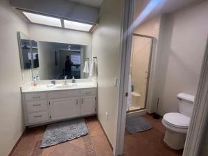 a bathroom with a sink and a toilet and a mirror at Hopi Keys House in Parker