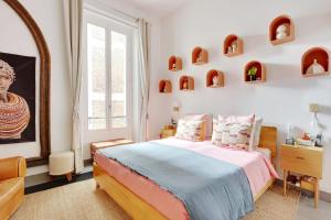 a bedroom with a bed and a large window at Very nice apartment Atypical 6 People in Paris