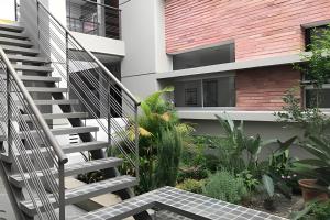 a staircase leading up to a building with plants at Tango Apartment, p/ 4 personas, con cochera. in Salta