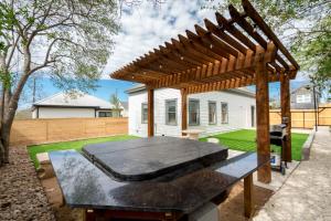 a picnic table in a backyard with a pergola at Perfect Spacious Modern Home w/Hot Tub in San Antonio