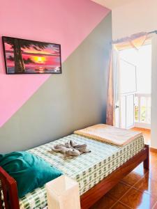 a bedroom with a bed with a picture on the wall at Casa BB&Djassi in Ponta do Sol