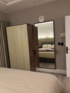 a bedroom with a large mirror and a bed at Double Night in Riyadh