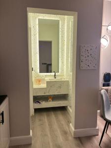 a dressing room with a mirror and a vanity at Double Night in Riyadh