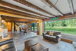 a living room with a couch and a table at Dog-Friendly 3BR on 200 Acres w/ River Access in Sloat