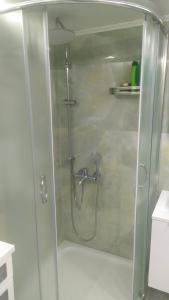 a shower with a glass door in a bathroom at Blue Beach Siviri Chalkidiki in Siviri