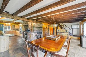 a large kitchen with a wooden table and chairs at Dog-Friendly 3BR on 200 Acres w/ River Access in Sloat