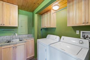 a kitchen with a washing machine and a sink at Dog-Friendly 3BR on 200 Acres w/ River Access in Sloat +28 photos