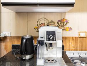 a kitchen with a coffee maker on a counter at luxury Heliopolis gem in Cairo