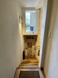 a hallway with a staircase with a window and a window at Village house Stella in Saint-Cannat +8 photos