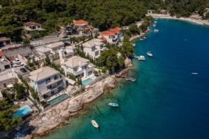 an aerial view of a group of houses and boats in the water at Luxury Villa Bohemian 1 & 2 heated pool near sea in Selca