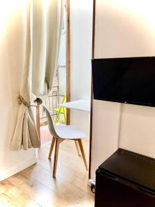 a room with a chair and a table and a television at Hotel S. Ercolano in Perugia