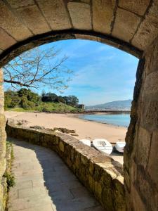 a view of the beach from a stone bridge at O Recuncho de Belén in Baiona