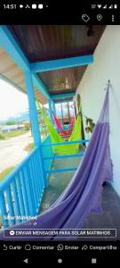 a picture of two hammocks on a porch at Pousada paraíso no Mar in Matinhos