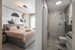 um quarto com uma cama e uma casa de banho com um chuveiro em Apartment Arbora em Novigrad Istria
