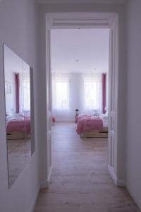 an empty room with two beds and a mirror at Wagner Villa 902 with free private parking in Budapest +49 photos