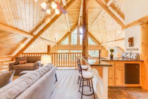 a living room and kitchen in a log cabin at Mountain Cabin with Hot Tub 4 Mi to Shaver Lake! in Shaver Lake