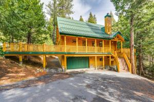 a log cabin with a deck and a garage at Mountain Cabin with Hot Tub 4 Mi to Shaver Lake! in Shaver Lake