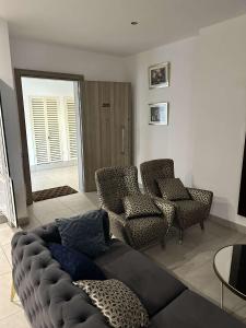 a living room with a couch and chairs at Pine Court in Accra