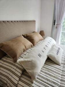 a bed with two pillows on top of it at Tigre Studio Apartment in Tigre +59 photos
