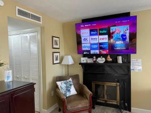 a living room with a fireplace and a large screen television at Gatlinburg Summit Studio for 2 With Amazing View! in Gatlinburg