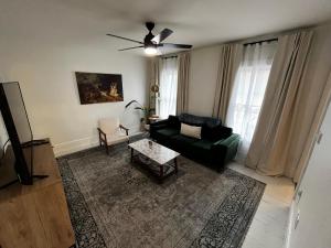 a living room with a couch and a table at Charming & Newly Renovated 2BR in St Albans in Saint Albans