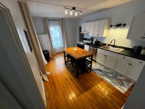 a kitchen with a table in the middle of it at Charming & Newly Renovated 2BR in St Albans in Saint Albans