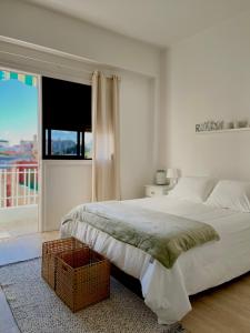 a white bedroom with a large bed and a window at Santo Domingo in Santa Cruz de Tenerife